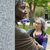 Photograph of bronze statue of a woman, with live woman placing purple flowers into statue's hand.