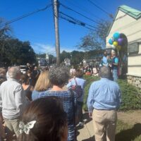 A crowd views people speaking