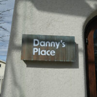 Sign at alternate entrance to Dannys Place in Acton