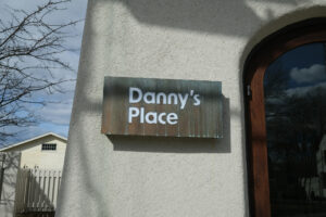 Sign at alternate entrance to Dannys Place in Acton