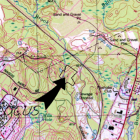 A dard arrow and an outlined location on a topographic map