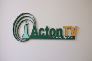 Acton TV logo in 3D hanging on a wall