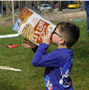 A visitor observing the eclipse with a pinhole camera