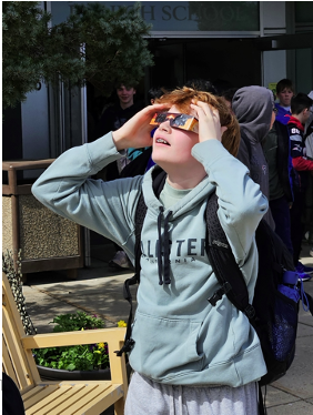 Student viewing the eclipse using ISO compliant eclipse glasses