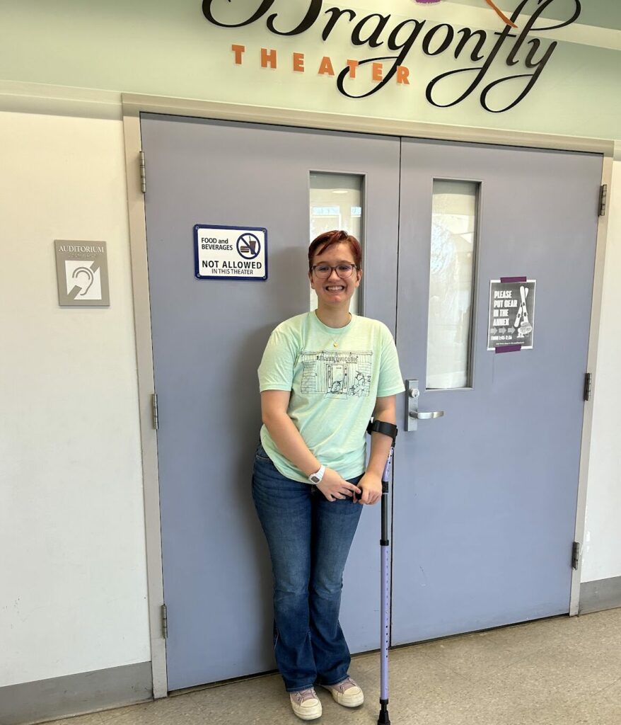 Actor Evvy Shoemaker at the door to Dragonfly Theater