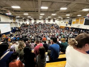 The AB upper gym is packed with voters for the first night of Town Meeting.