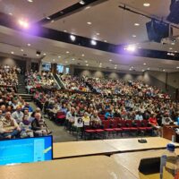 The auditorium filled with people, viewed from the stage.