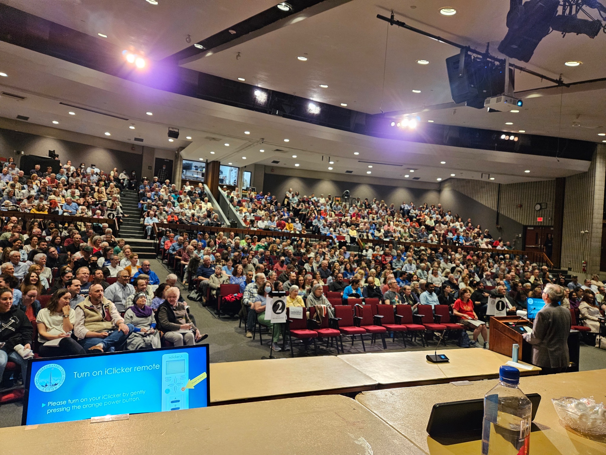 The auditorium filled with people, viewed from the stage.