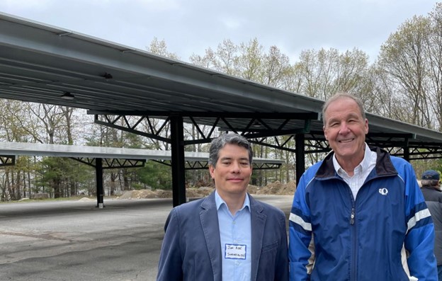 Congregation Beth Elohim Solar Partners Sunwealth Power CEO Jon Abe and 621 Energy Owner Bob Clarke with solar carports in the background