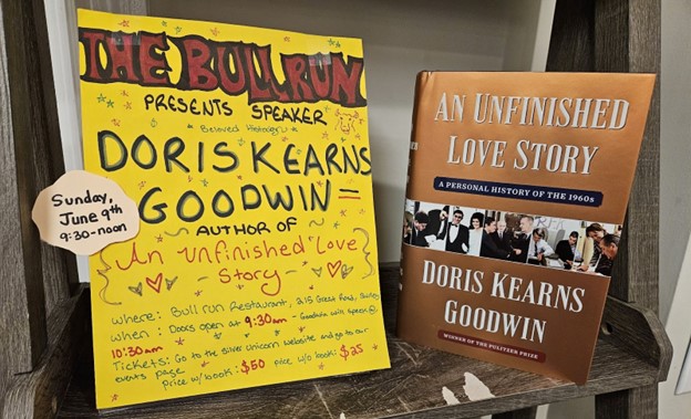 A handwritten poster announcing Doris Kearns Goodwin as a speaker at Bull Run Restaurant on June 9, and a picture of the cover of Goodwin's newest book, An Unfinished Love Story.