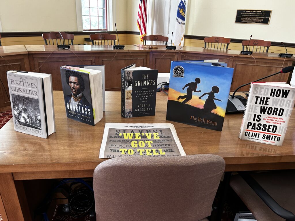 A table with books. Some of the titles include The fugitive's Gibralter, by Kathryn Grover; How the Word is Passed, by Clint Smith, and The Bell Rang, a children's book by James E Ransome.