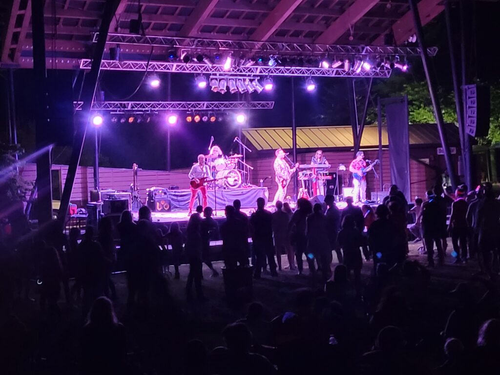 Five band members on the the NARA park stage are singing Cars tunes.