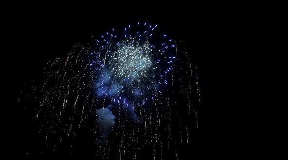 White fireworks in a circle from the side.
