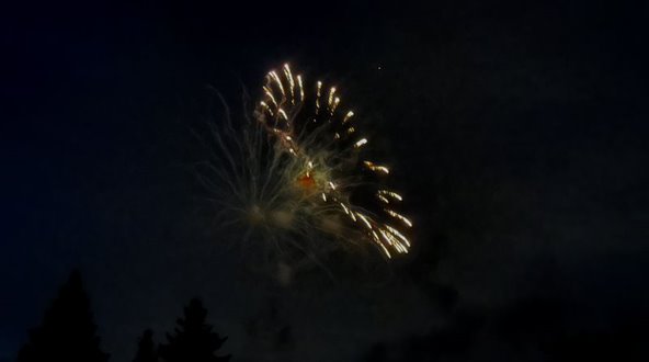 White fireworks in a circle from the side.