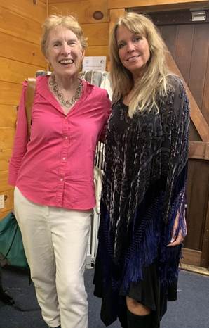 Two women, one with short blond hair and the other with long blond hair. The woman on the right wears a sparkly dress (her Stevie Nicks costume).