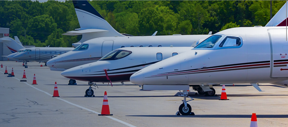 Planes and jets are lined up on the tarmac.