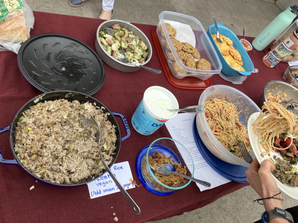 Another table full of tasty treats including a Middle Eastern lentil and rice dish and Asian-style peanut noodles.