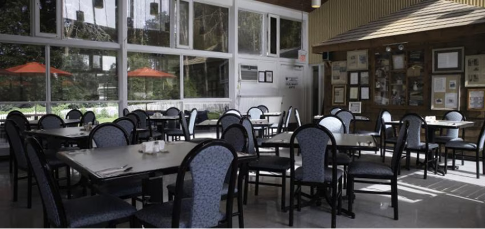 A small restaurant dining room The room is sunny and looks comfortable.