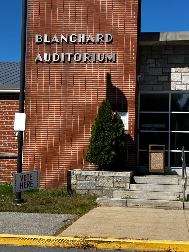 The Blanchard Auditorium entrance to the Junior High. A Vote Here sign is in front.