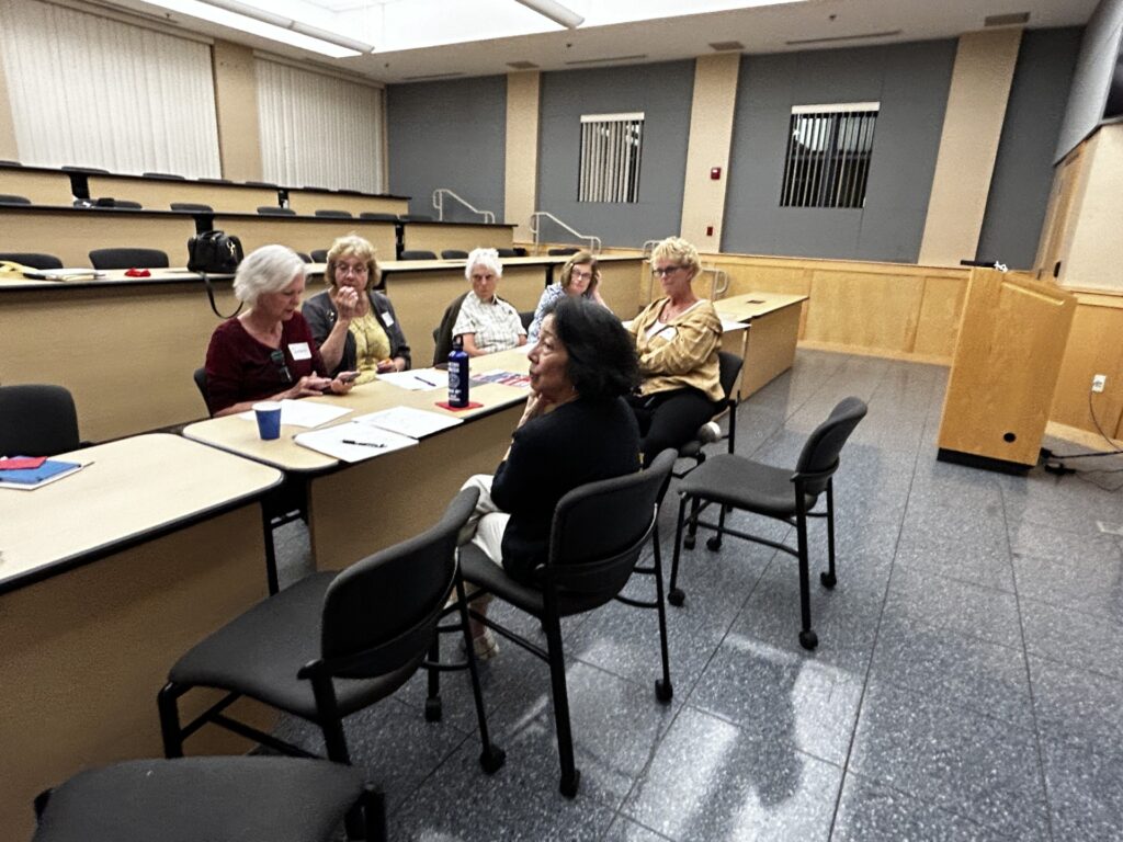 A group of woman having a discussion at a table.