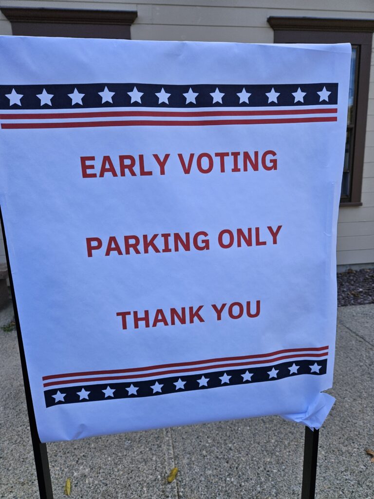 A sign on a sandwich board that states: Early voting parking only. Thank you.