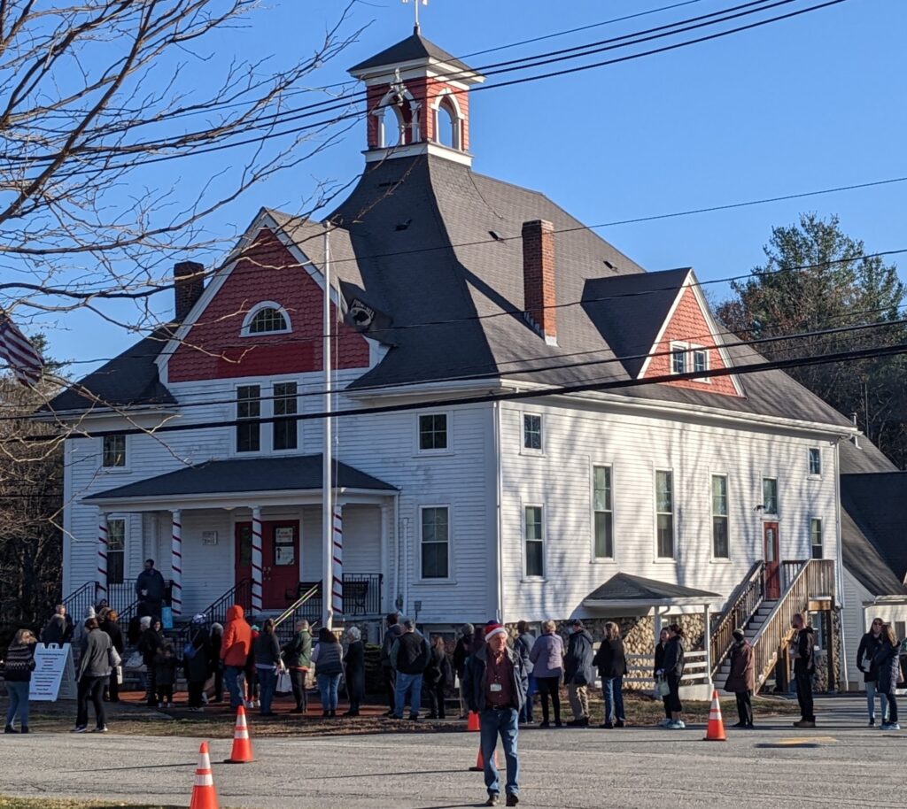 People are lined up in front of Boxborough Town Hall, waiting for a previous Merrie Christmas Fair to open.