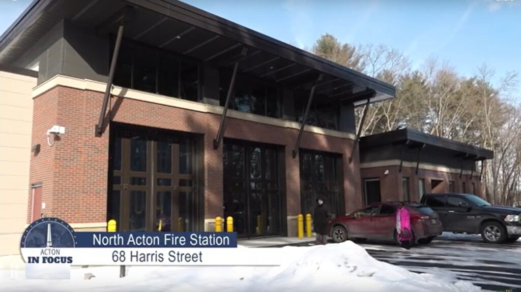 The North Acton fire station with all three bay doors closed. A pile of snow is in the foreground.