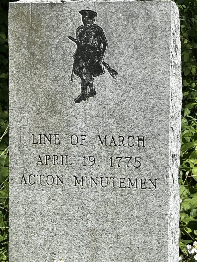 A granite marker (about 3 feet high) engraved with a picture of a Minuteman and the following words: "Line of march, April 19, 1775, Acton Minutemen. The marker is one of nine along the Isaac Davis Trail in Acton.