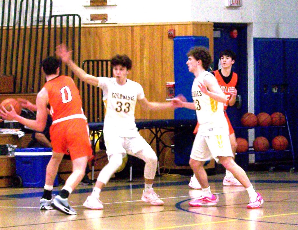 Two players in AB jerseys block a Wayland player.