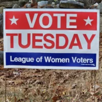 A League of Women Voters Vote Tuesday sign in the grass.