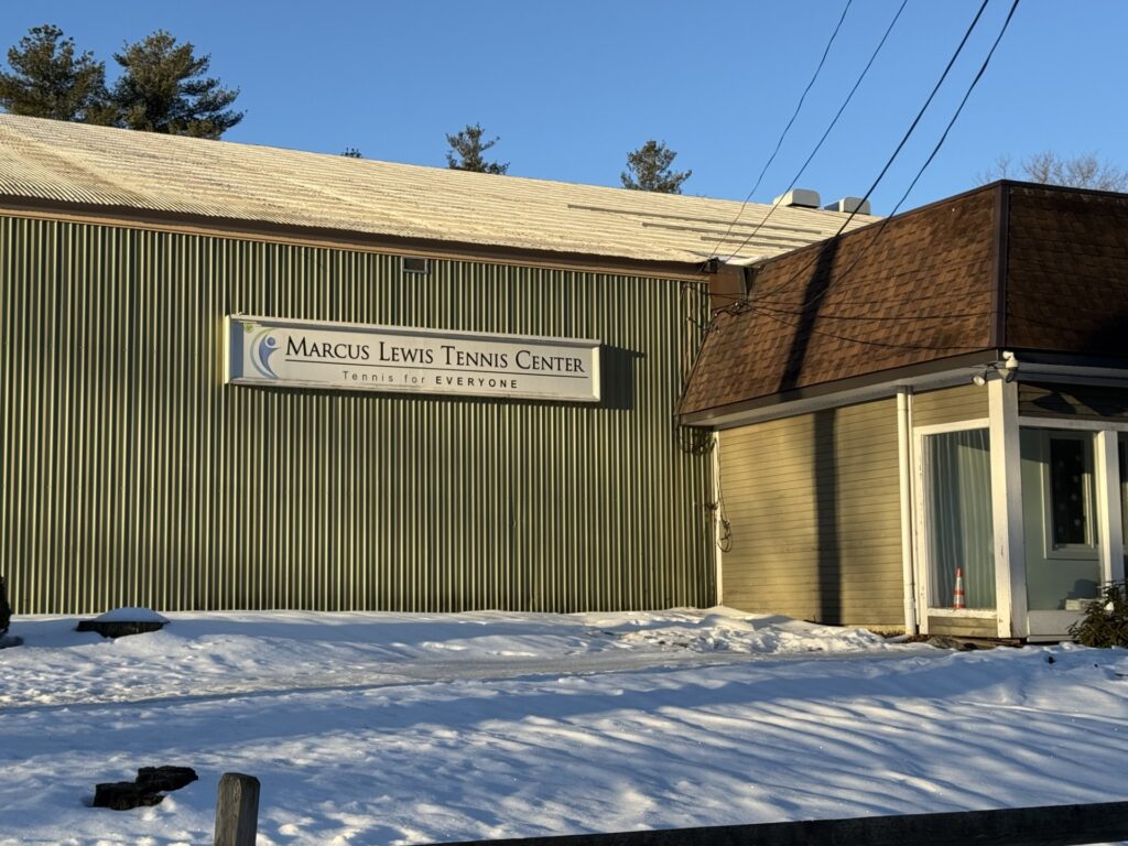 A building with the Marcus Lewis Tennis Center sign.